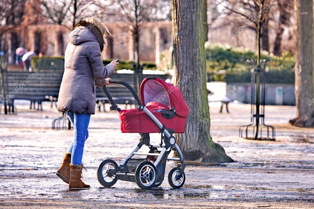 Young woman walking with her baby in the park