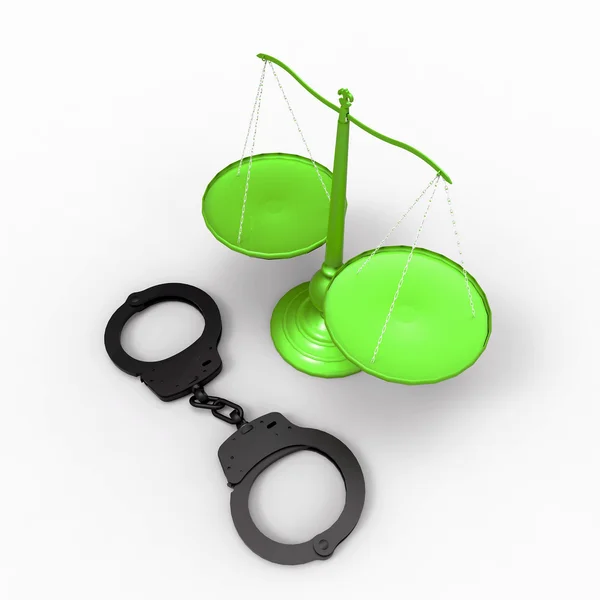 Весы правосудия и наручники — стоковое фото