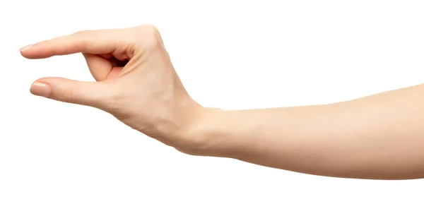 La mano femenina sostiene los dedos invisibles del objeto. Espectáculo de palma pellizco o tamaño Aislado en blanco — Foto de Stock