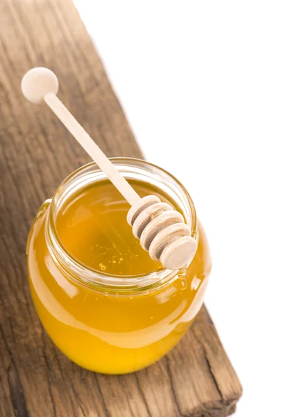 Honey in bank on wooden boards — Stock Photo, Image