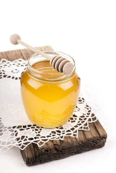 Honey in bank on wooden boards — Stock Photo, Image