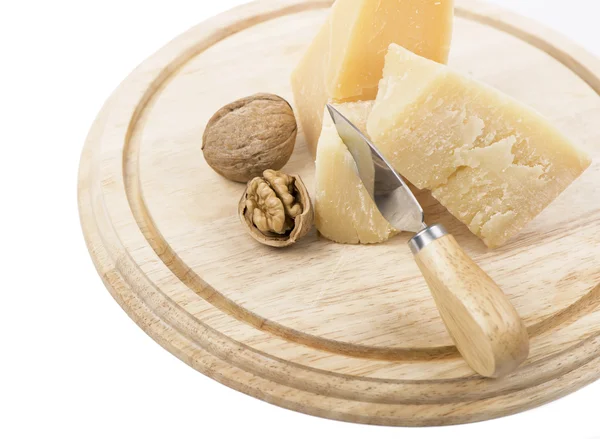 Nuts and cheese on wooden board. — Stock Photo, Image