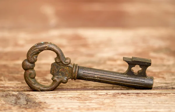 Retro key on wooden table — Stock Photo, Image