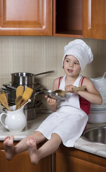 Girl in a cap and an apron — Stock Photo, Image