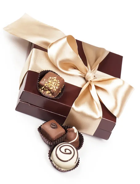 Brown box with candies and golden tape — Stock Photo, Image