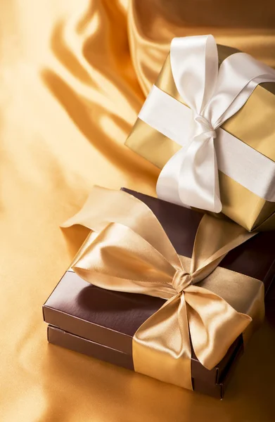 Bruine doos met snoepjes en gouden tape — Stockfoto