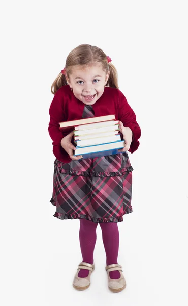 Niña sosteniendo libros —  Fotos de Stock