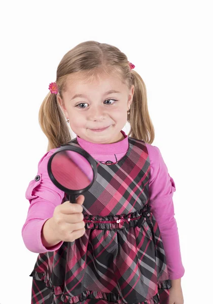 Little girl looking through a magnifying glass carefully — Stock Photo, Image