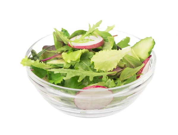 Salad from cut cucumbers, garden radish and lettuce leaves — Stock Photo, Image
