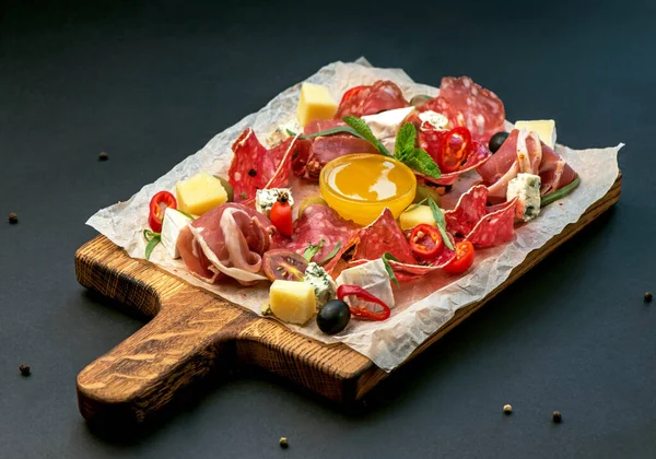 Pirzola - jambon, jambon, siyah arka planda tahta üzerinde salam