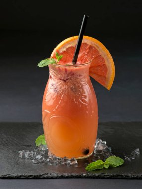 Jar of grapefruit juice and ingredients on wooden background