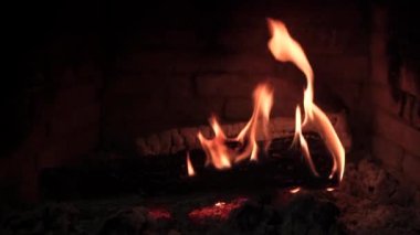 Koyu arkaplanda odun parçaları yakılıyor