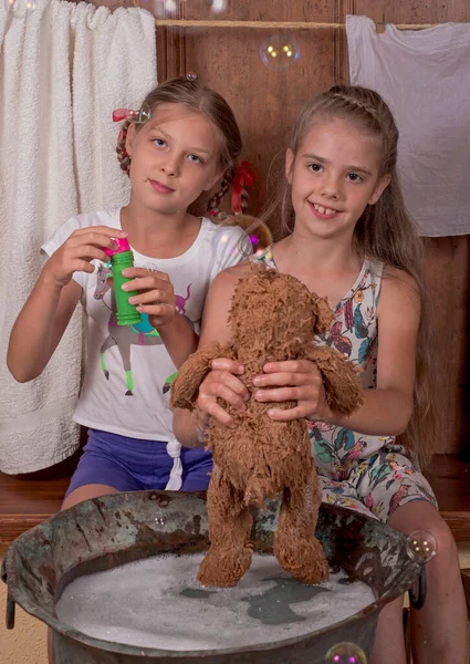 Two Girlfriends Cute Happy Girls Bathe Teddy Bears Blow Bubbles — Fotografia de Stock