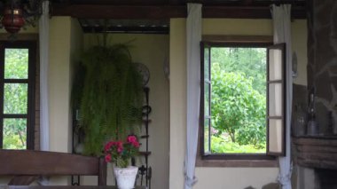 close up of happy woman closes a window in a country house