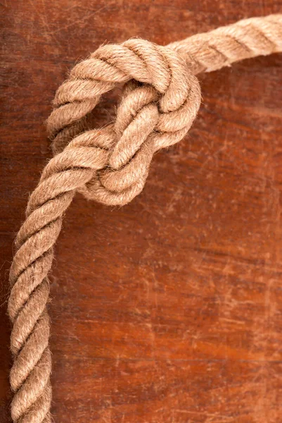 Rope with Reef Knot on Wood Texture