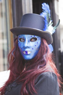 Young female in blue mask.