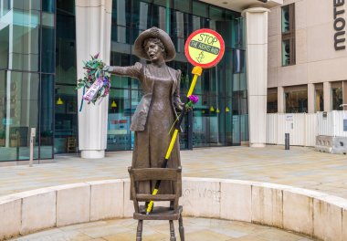 Manchester, UK - October 10, 2021: The statue of Emmeline Pankhurst is decorated by Amnesty International representatives to mark the STOP THE RIGHTS RAID Week of Action 10-17 October 2021. clipart