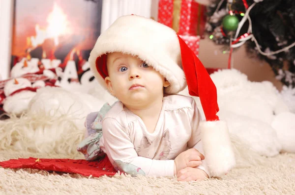 Little happy Christmas girl in santa's hat — Stock Photo, Image
