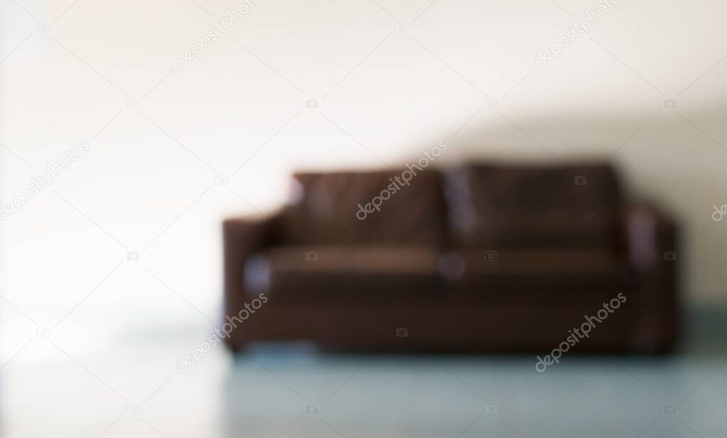 A blurry image of a leather sofa in the hallway of an office building