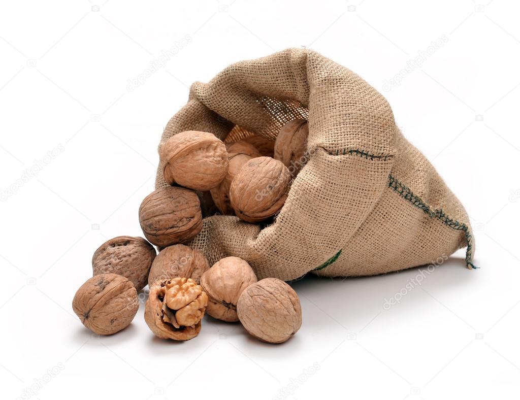 Walnuts and a bag on white