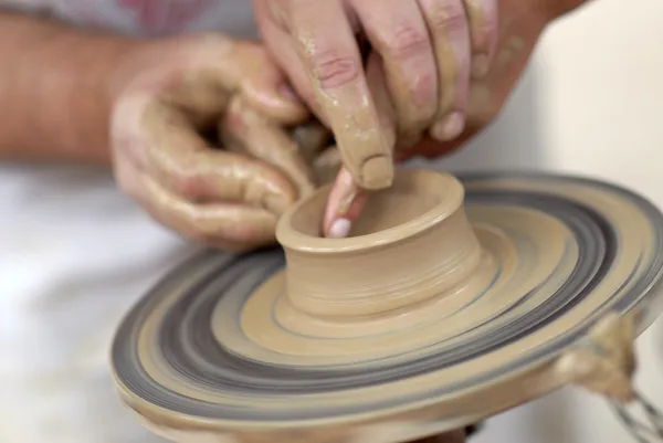 Hands working on pottery wheel — Stock Photo, Image