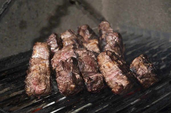 Beef steak cooking on an open flame grill — Stock Photo, Image