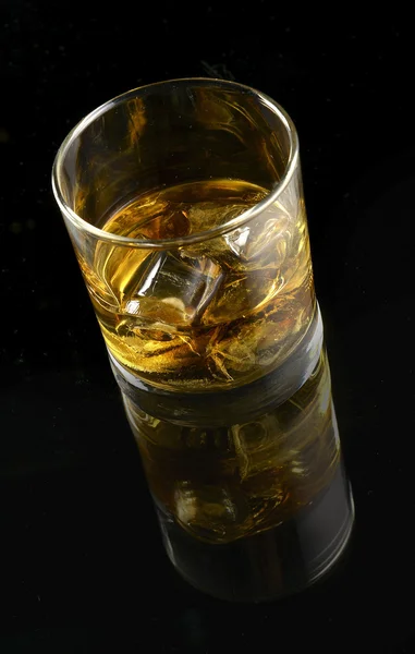 Whiskey with ice in a glass — Stock Photo, Image