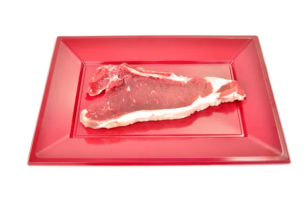 Chop  raw cow on red tray isolated — Stock Photo, Image