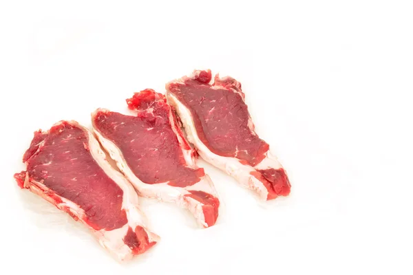 Drie Spaanse rundvlees steaks op papier geïsoleerd — Stockfoto