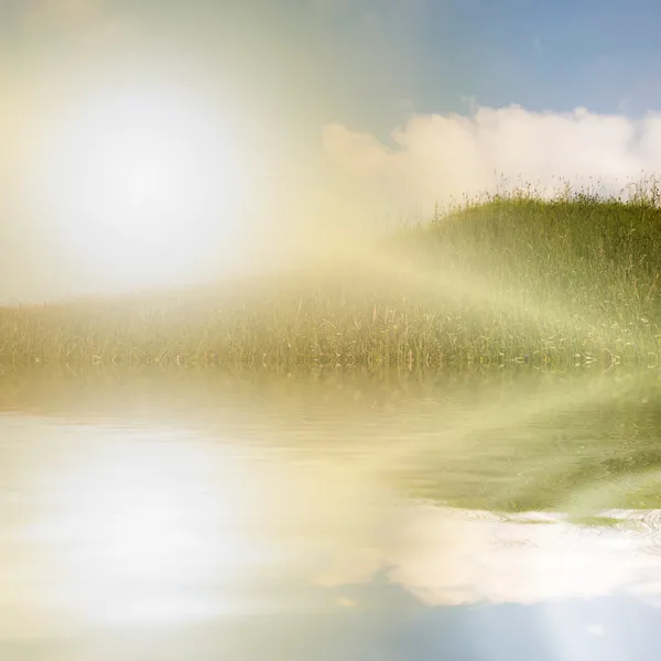 Fluss und grüner Hügel an einem sonnigen Sommertag — Stockfoto