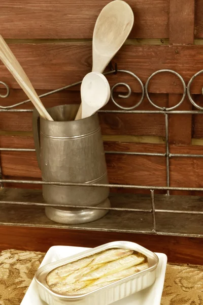 Sardines in olive oil and kitchen utensils — Stock Photo, Image