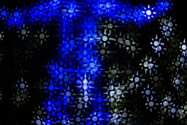 Abstract blurry, low depth of field bokeh light shapes. Vivid, colourful light effects background picture with different shapes and dots in various colours. Perfect for Christmas backgrounds