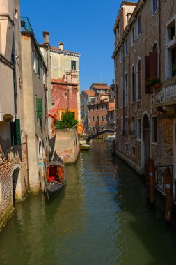 Venice canals, Venice, Veneto, Italy. July 25, 2022. Editorial stock picture of boats sailing, or boats docked in the canals of the beautiful city of Venice, Italy.