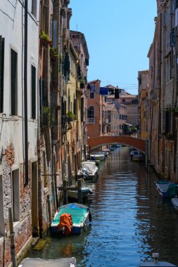 Venice canals, Venice, Veneto, Italy. July 25, 2022. Editorial stock picture of boats sailing, or boats docked in the canals of the beautiful city of Venice, Italy.
