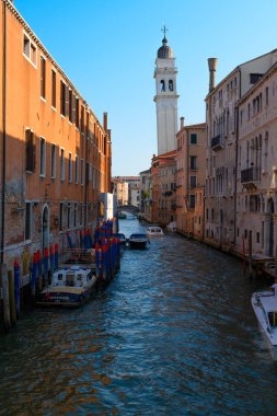 Venice canals, Venice, Veneto, Italy. July 25, 2022. Editorial stock picture of boats sailing, or boats docked in the canals of the beautiful city of Venice, Italy.