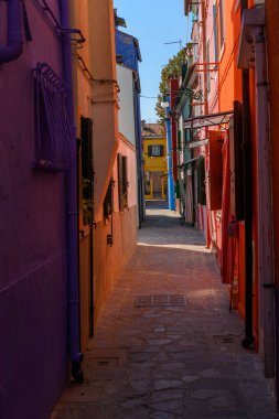 Burano island, Venice, Veneto, Italy. July 25 2022. Editorial stock picture of the streets, alleys and very colorful small houses on the small island of Burano, Venice, Italy. Burano is known for its lace and these multi colored houses. It is a beaut