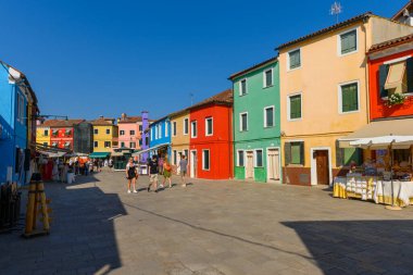 Burano island, Venice, Veneto, Italy. July 25 2022. Editorial stock picture of the streets, alleys and very colorful small houses on the small island of Burano, Venice, Italy. Burano is known for its lace and these multi colored houses. It is a beaut