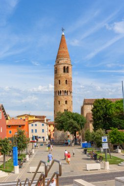 Campanile del Duomo di Caorle, Caorle, Veneto, Italy. July 27, 2022. Editorial stock picture of the bell tower of the cathedral in Caorle, Italy. Campanile del Duomo di Caorle is situated at a small town square, and is a big tourist attraction.
