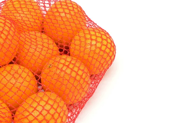 Oranges en maille du supermarché avec copyspace — Photo