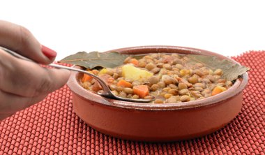 Brown lentil stew in bowl with vegetable clipart