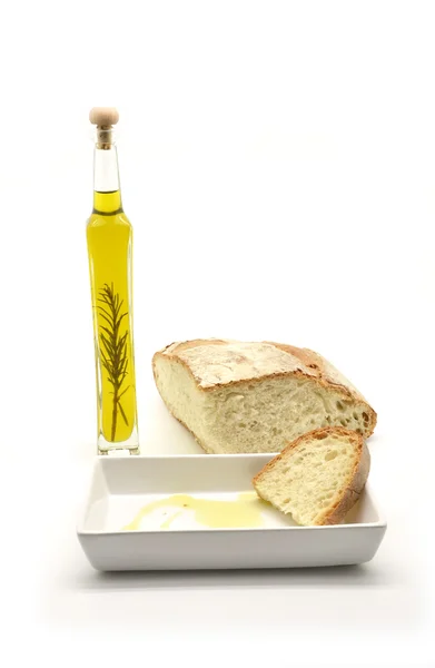 Oil flavored with rosemary branch and slice of bread — Stock Photo, Image
