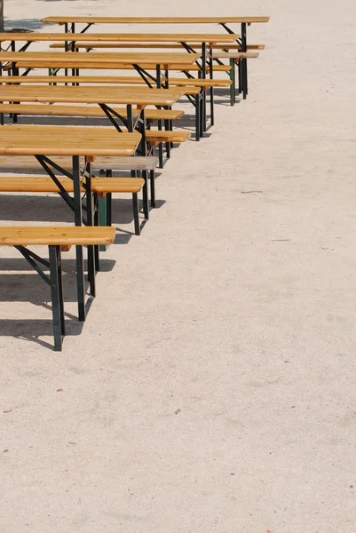 Wooden benches and tables in a row — Stock Photo, Image