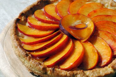 Fruit cake covered with fresh slices of peaches