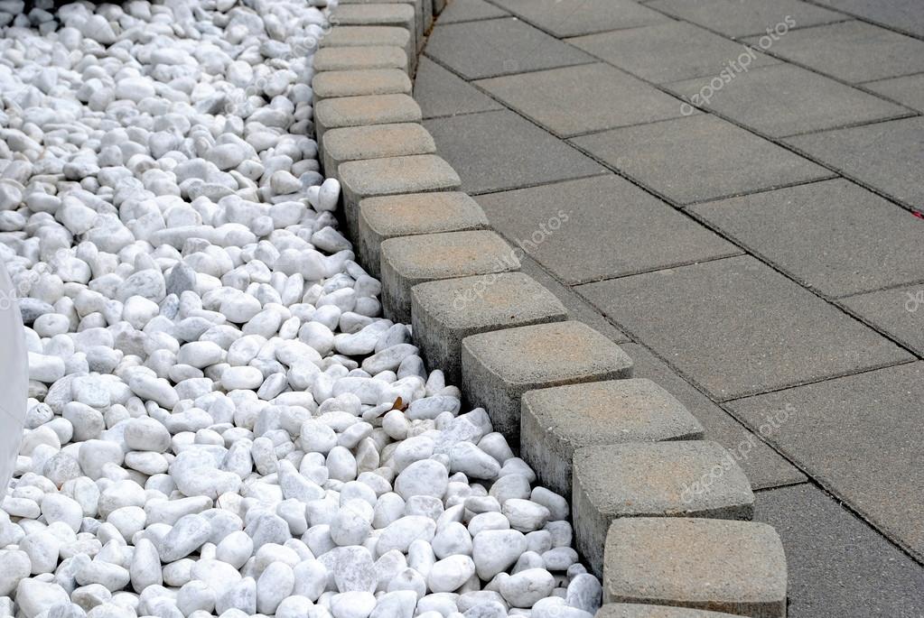 Flower bed border made of pebbles and stones