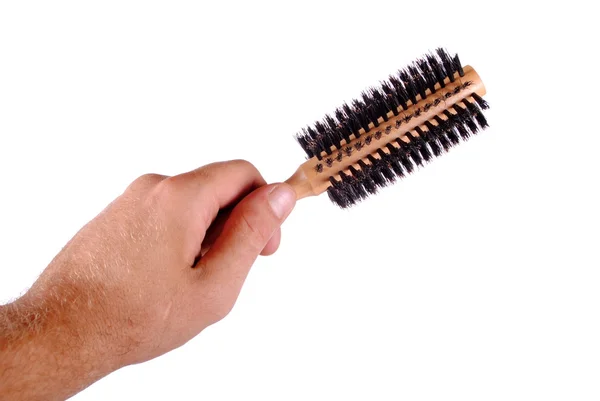 Mão segura uma escova de cabelo, isolado em branco — Fotografia de Stock