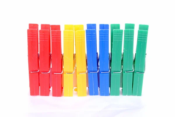 Colorful clothes pegs on white background soft shadows — Stock Photo, Image