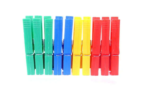 Colorful clothes pegs on white background soft shadows — Stock Photo, Image