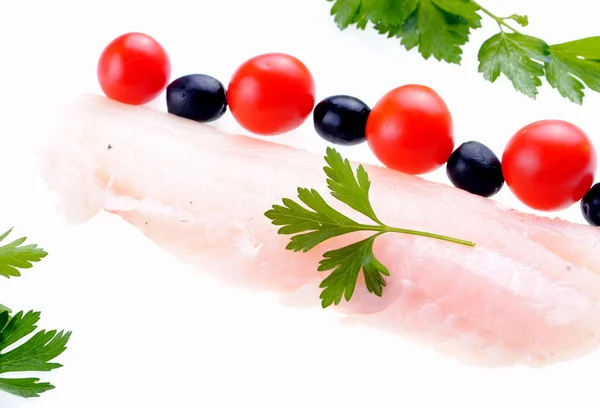 Cod steak with tomatoes olives and parsley isolated on white — Stock Photo, Image