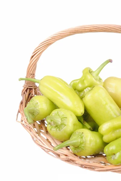 Green peppers in a straw basket, isolated on white — Stock Photo, Image