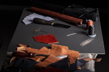 Work table with the tool of a craftsman for the manufacture of leather goods. clipart